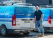Thoroughgood Professional Plumbing Services owner standing in front of branded Toyota HiAce fleet vans, Central Coast NSW